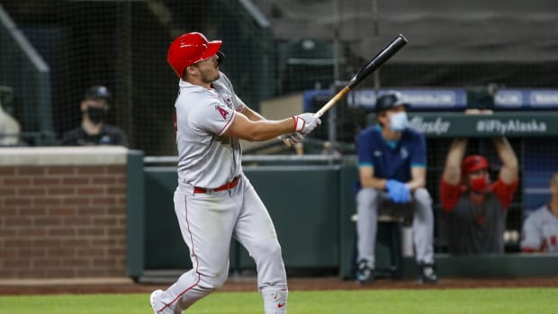 Aug 5, 2020; Seattle, Washington, USA; Los Angeles Angels center fielder Mike Trout (27) hits a three-run home run against the Seattle Mariners during the eighth inning at T-Mobile Park. Mandatory Credit: Joe Nicholson-USA TODAY Sports